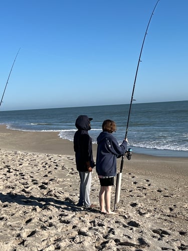 Three People Surf Fishing With One Fishing Pole At Cocoa Beach