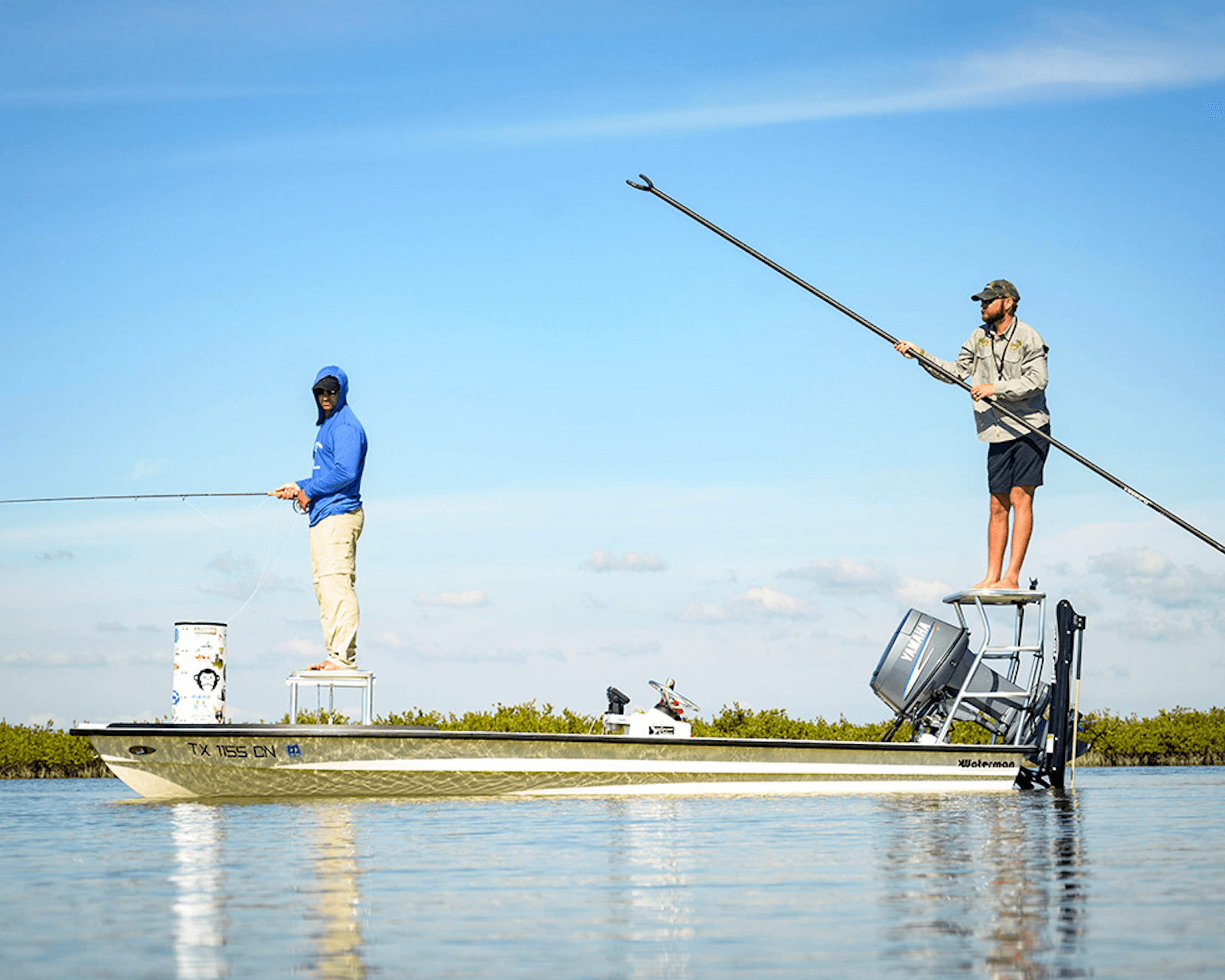 man poling skiff in rockport