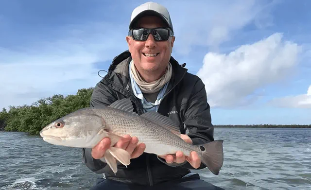 simon holding up a redfish in texas